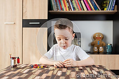 Cute boy assembling toys at his table Stock Photo