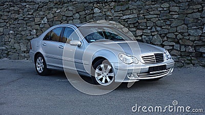 Cluj Napoca/Romania-March 31, 2017: Mercedes Benz W203 - year 2005, Avantgarde equipment, silver metallic paint near a rock wall p Editorial Stock Photo