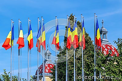 Romanian flags and roofs of the old building in Cluj-Napoca, Romania Editorial Stock Photo