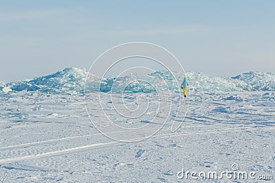 Clumps of blue ice on the snow. Stock Photo