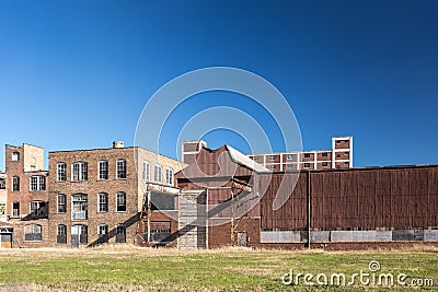 Cluster of industrial buildings left abandoned in small town Stock Photo