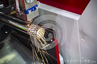 The CNC laser cut machine cutting the stainless pipe Stock Photo