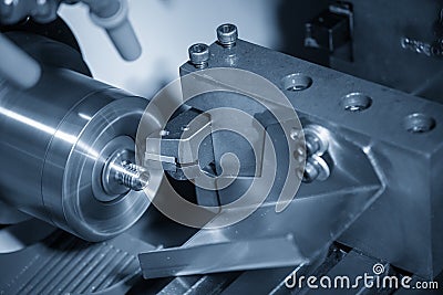 The CNC lathe machine in metal working process cutting the screw parts with the cutting tools. Stock Photo