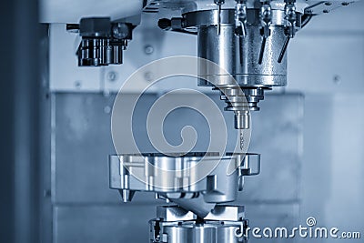 The CNC milling machine make the thread at the aluminium casting parts by tapping tool. Stock Photo