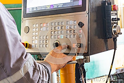 The cnc operator writes a program to control the metal processing machine. Management of the machining center Stock Photo