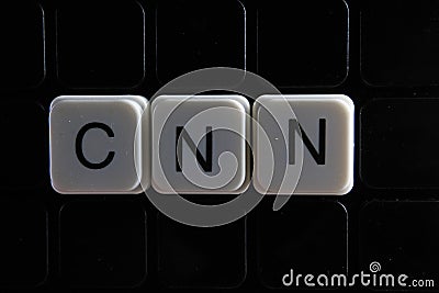 Cnn control text word title caption label cover backdrop background. Alphabet letter toy blocks on black reflective background. Stock Photo