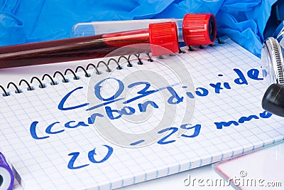 CO2 or carbon dioxide in serum or blood in basic metabolic test. Laboratory test tubes with blood smear, stethoscope or film and g Stock Photo