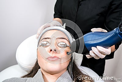 CO2 fractional ablative laser being used for skin rejuvenation skin resurfacing as a medical cosmetic procedure in a beauty Stock Photo