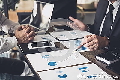 Co working conference, Business team meeting present, investor colleagues discussing new plan financial graph data on office table Stock Photo