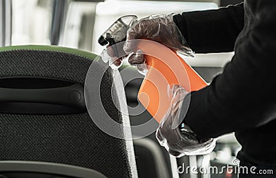 Coach Bus Owner Sanitizing and Cleaning Vehicle Seats Stock Photo