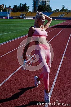 coach use skipping rope. sport success. tool for jumping. fitness sport fashion. lady jump workout Stock Photo