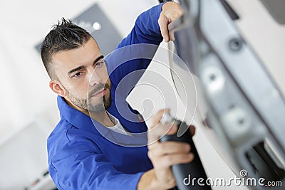 Coachbuilding student working on automobile in garage Stock Photo
