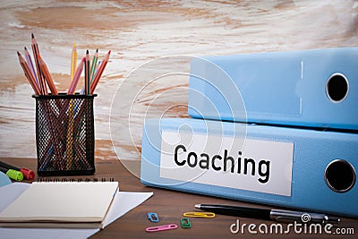 Coaching, Office Binder on Wooden Desk. On the table colored pen Stock Photo