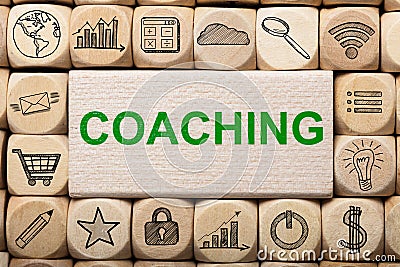 Coaching Text On Wooden Block Surrounded By Computer Icons Stock Photo