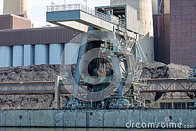 Coal crane with mountains of coal at coal power plant Stock Photo