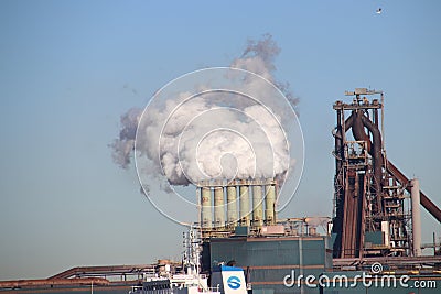 Coal and iron ore are unloaded at sea ships at the steel factory of Tata in IJmuiden the Netherlands. Editorial Stock Photo