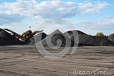 Coal loading excavator, heaps of coal Stock Photo