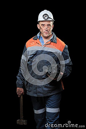 Coalminer holds out a large chunk of energy rich Stock Photo