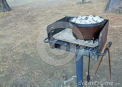 Coals on the Lid of a Dutch Oven Cooking Dinner 2 Stock Photo