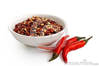 Coarsely ground chilli peppers in white ceramic bowl isolated on Stock Photo