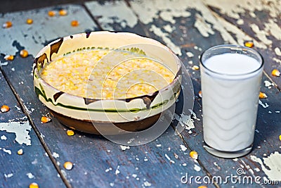 Coarsely ground maize with milk Stock Photo