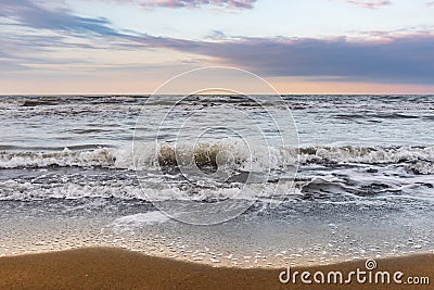 Coast, cloudy weather, waves on the sea Stock Photo