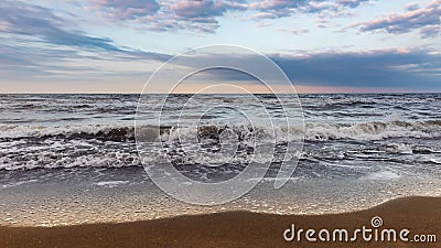 Coast, cloudy weather, waves on the sea Stock Photo