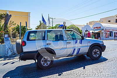 Coast guard car driving on a street in Fira capital town of Santorini in the summertime Greece Editorial Stock Photo