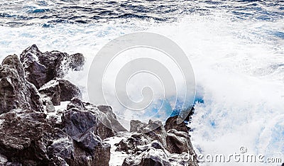 Coast with Stones of volcanic flow and ocean Stock Photo