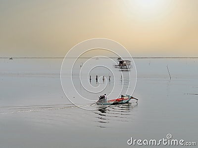 Coastal fishing boats are sailing after raining on sunset at the bay of Bangsaen, Thailand Stock Photo