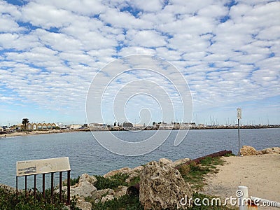 Coastal landscape of small houses on a sunny day with white clouds in the backdrop in Australia Editorial Stock Photo
