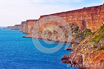 Coastal red rocks and blue Sea Landscape Summer Traveling Stock Photo