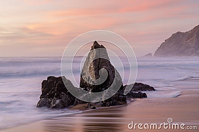 Coastal rock stack Sunset at Gray Whale Cove State Beach. Stock Photo