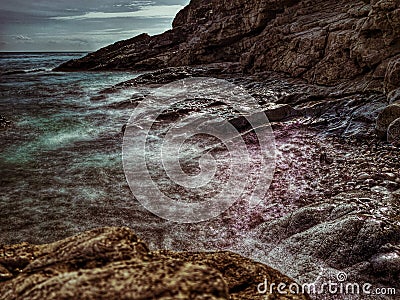 Coastal seascape, tide coming in over a rocky beach. Stock Photo