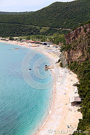 Coastline with Jaz beach in Budva municipality in Montenegro. Parasols with sun beds are on Adriatic sea shore Stock Photo