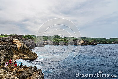 Coastline on Nusa Penida island near Angel`s Billabong beach with tourists Editorial Stock Photo