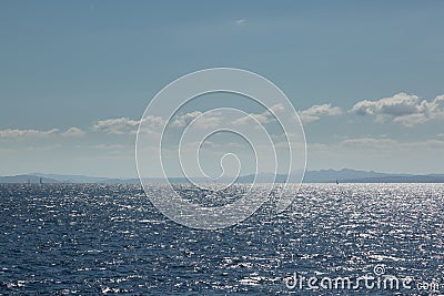 Coastline of Sardinia with several sailing boats in sunshine Stock Photo