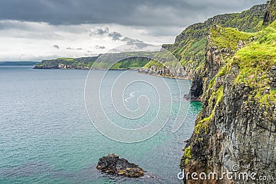 Coastline with tall limestone cliffs and turquoise Atlantic Ocean, near Carrick a Rede rope bridge Stock Photo