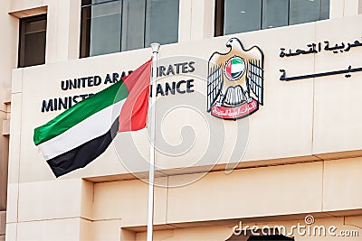 Coat of arms and flag at the Ministry of Finance of the United Arab Emirates in Dubai, which is part Editorial Stock Photo