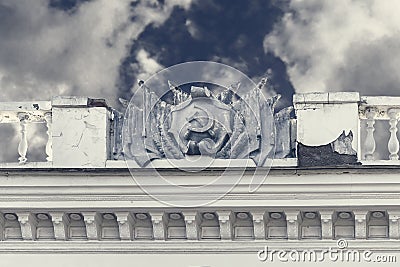 Coat of arms and flags of USSR of plaster on facade of old building. Crimea, Sudak - 10 October 2020 Editorial Stock Photo