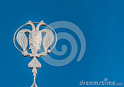 Coat of arms of Russia, silver double-headed eagle against the background of blue sky. Silver Russian heraldic symbol, background Stock Photo