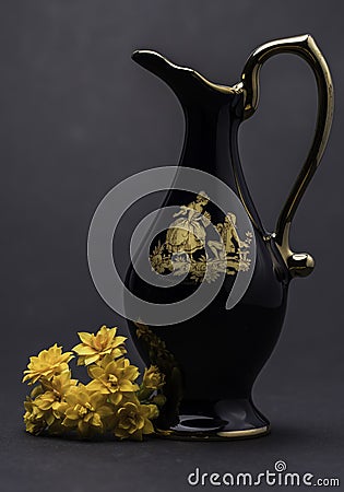 Cobalt Blue Pitcher Carafe Vase with Yellow Flower and Grey Background Stock Photo