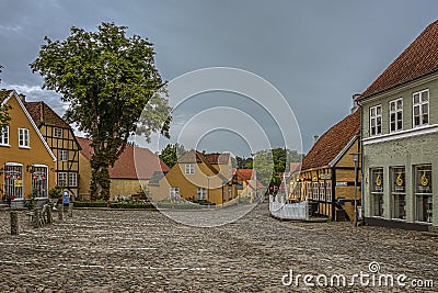 Cobbled square with roses and vintage timber framed houses in the dusk evening light Editorial Stock Photo