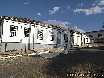 Cobbled street lined with colonial houses Stock Photo