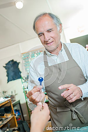 Cobbler holding two keys Stock Photo