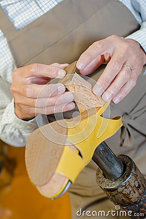 Cobbler mending heel shoe Stock Photo