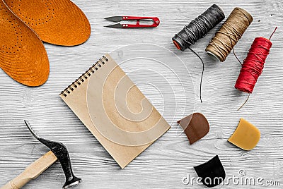 Cobbler takes order. Notebok on grey wooden desk background top view mockup Stock Photo