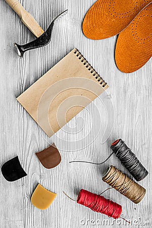 Cobbler takes order. Notebok on grey wooden desk background top view mockup Stock Photo