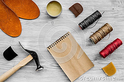 Cobbler takes order. Notebok on grey wooden desk background top view mockup Stock Photo