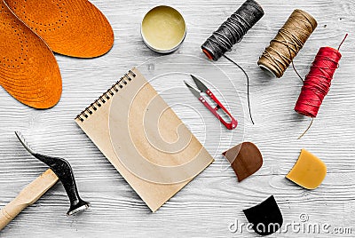 Cobbler takes order. Notebok on grey wooden desk background top view mockup Stock Photo